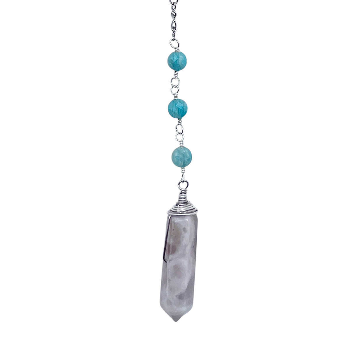Ruby Feathers Celestial Calm pendulum with a cloud agate point, amazonite beads, and a silver spiral on a steel chain.