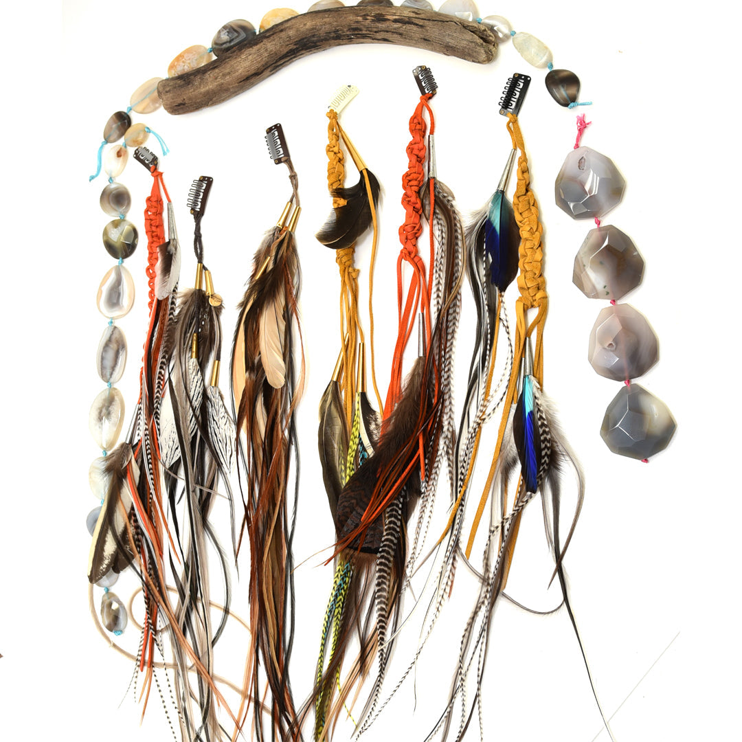Ruby Feathers handmade hair clip extensions featuring calfskin leather, mixed natural feathers, and brass accents.