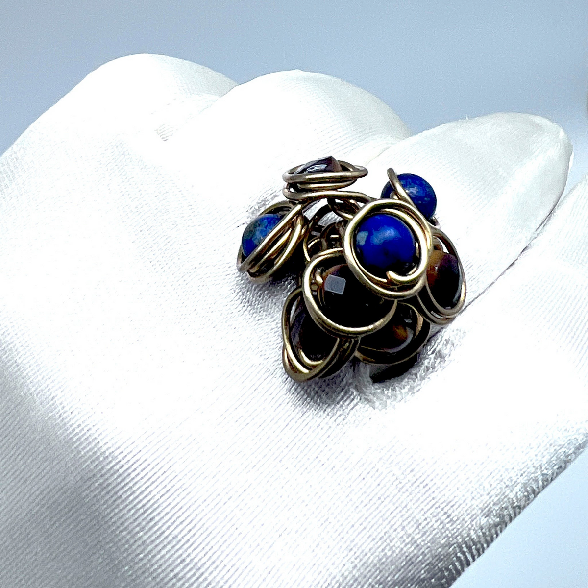 Ruby Feathers handcrafted statement ring with Lapis Lazuli and Tiger's Eye stones wrapped in organic brass wire.