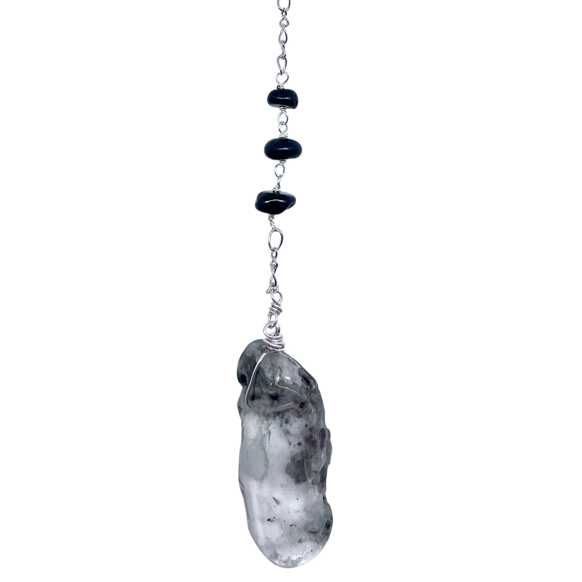 Ruby Feathers Aegis Shadow pendulum featuring a raw smoky quartz crystal, black tourmaline beads, and silver chain.