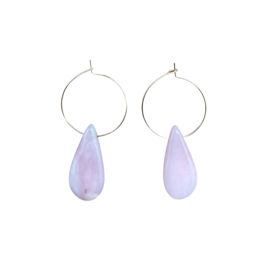 Ruby Feathers gold-plated hoop earrings featuring natural teardrop-shaped pink opal gemstones on a leather background.