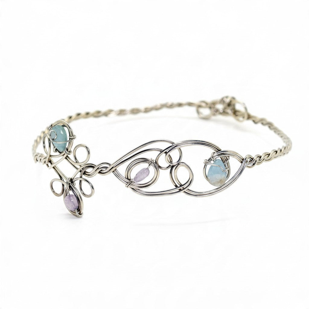Ruby Feathers Astra Halo crown featuring amethyst and beryl stones woven into silver-covered copper wire.