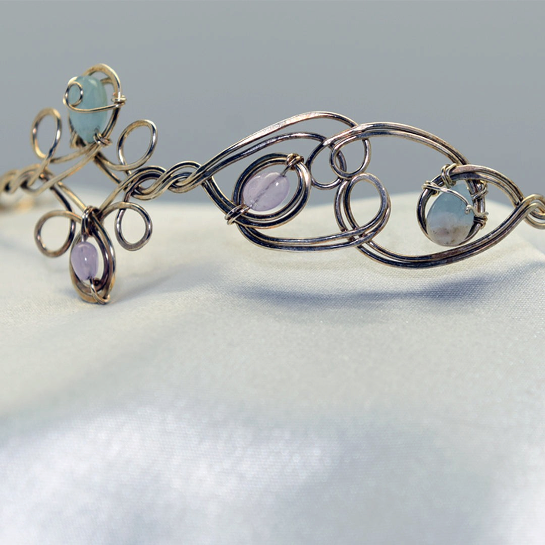 Ruby Feathers Astra Halo crown featuring amethyst and beryl stones woven into silver-covered copper wire.