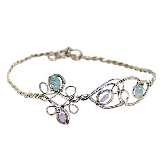 Ruby Feathers Astra Halo crown featuring amethyst and beryl stones woven into silver-covered copper wirework.