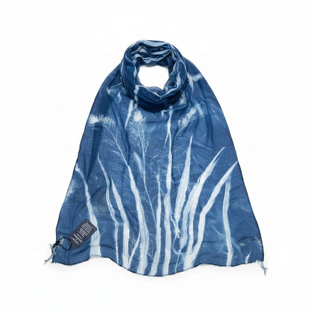 Ruby Feathers one-of-a-kind blue cotton scarf with sun-printed feather and lace patterns on a white background.