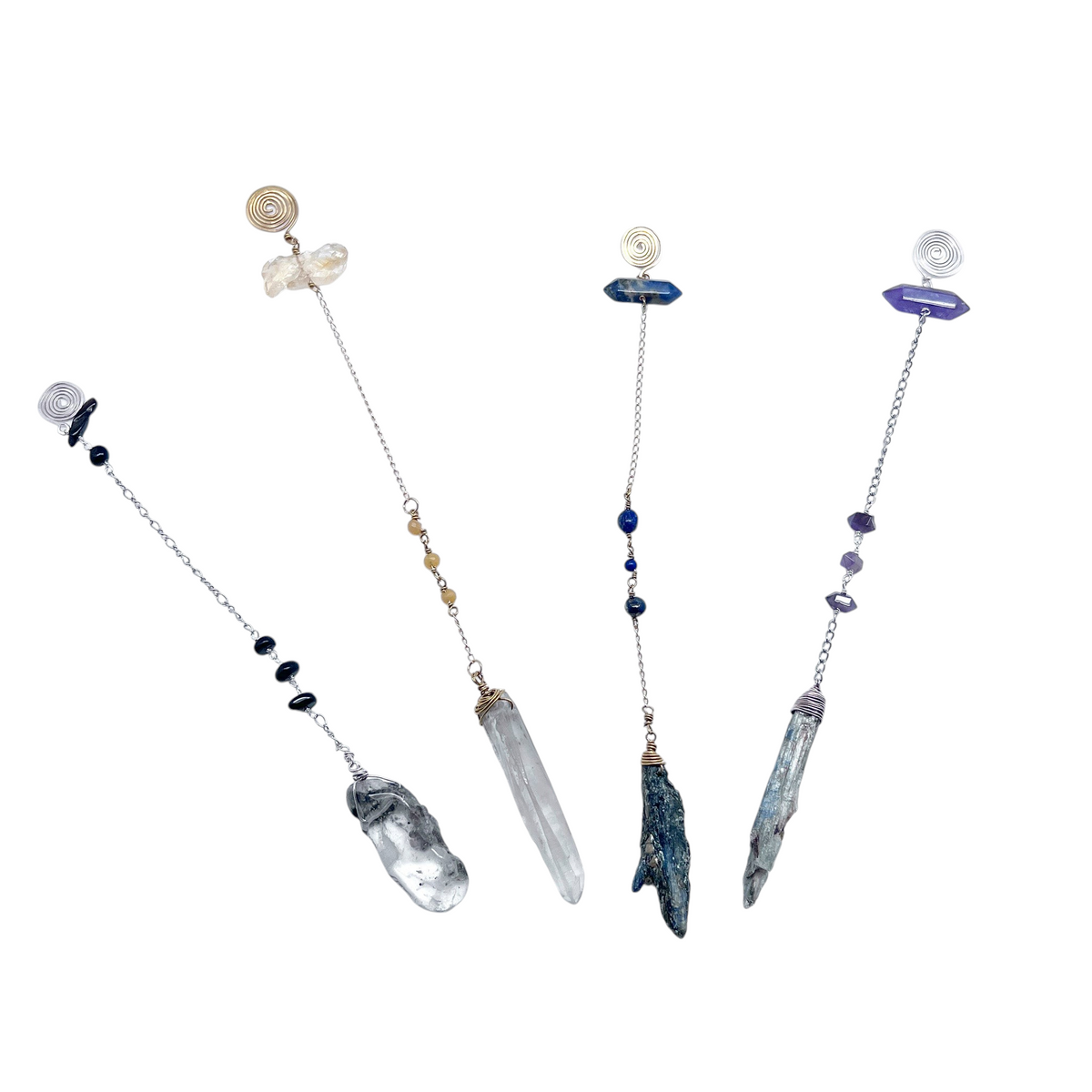 Ruby Feathers handcrafted crystal pendulums with smoky quartz, black tourmaline, and silver chains for energy work.