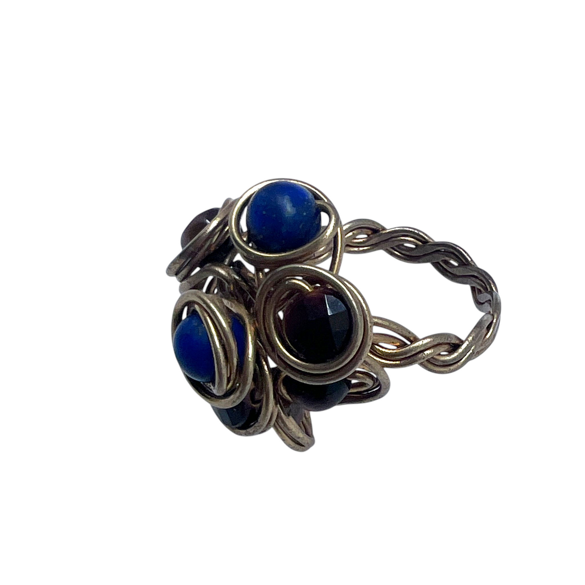 Ruby Feathers handcrafted statement ring with blue Lapis Lazuli and brown Tiger's Eye beads in braided brass wire.