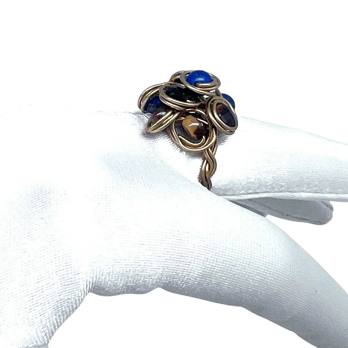 Ruby Feathers handcrafted cluster ring featuring blue Lapis Lazuli and brown Tiger's Eye stones wrapped in brass wire.