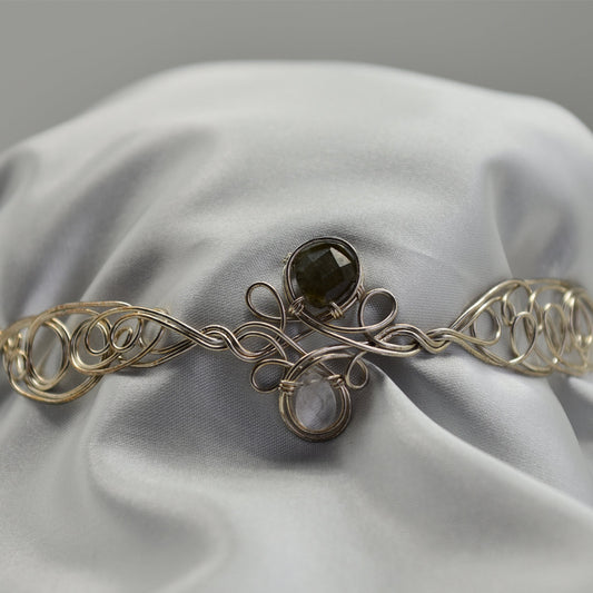 Ruby Feathers Moonveil Halo crown featuring labradorite and moonstone set in intricate silver-covered copper wirework.