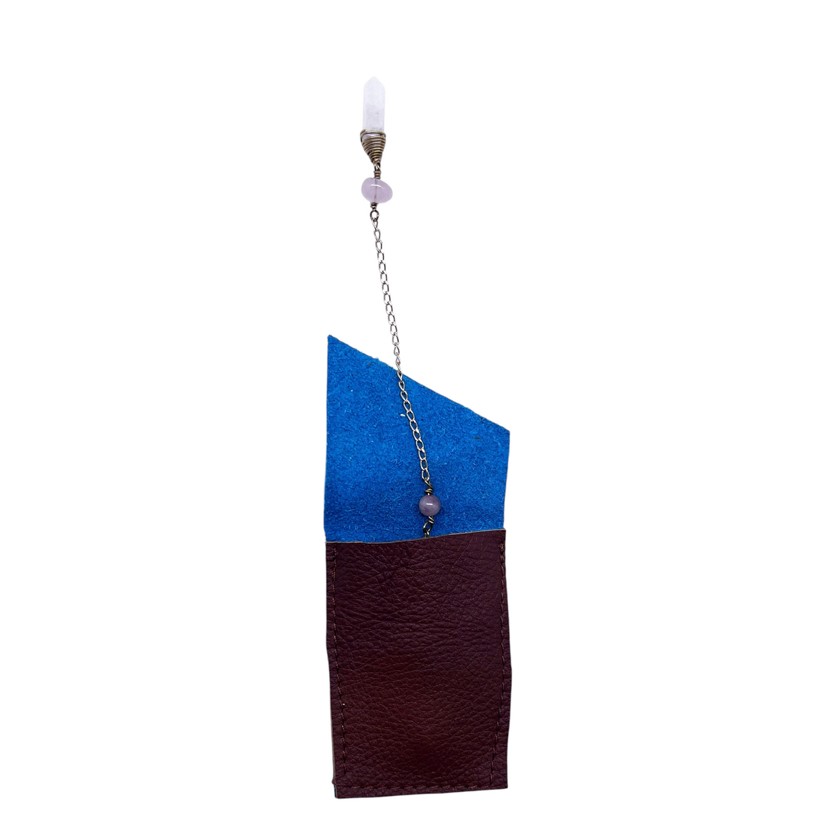 Ruby Feathers Sacred Flame pendulum with fire agate point and rose quartz beads, hanging above a leather pouch.