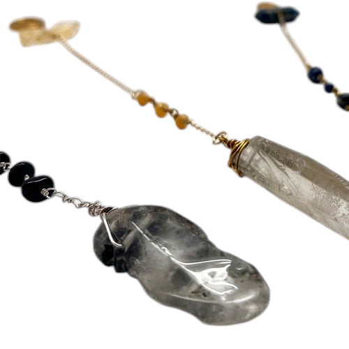 Ruby Feathers Aegis Shadow pendulum featuring smoky quartz and black tourmaline crystals on a silver-toned steel chain.