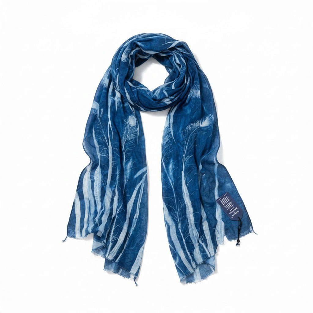 Ruby Feathers one-of-a-kind blue sun-printed cotton scarf with white feather and lace patterns on white background