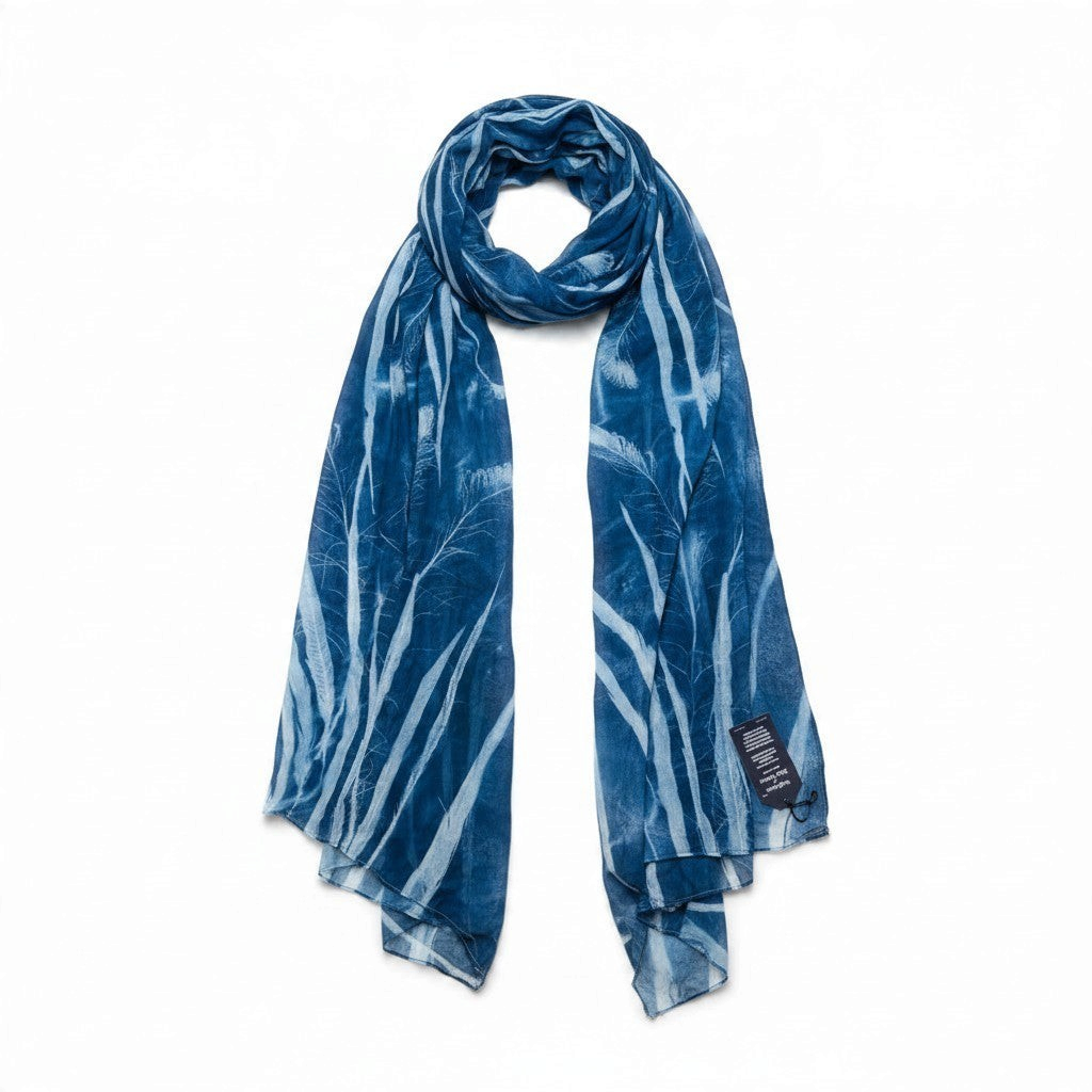 Ruby Feathers upcycled cotton scarf with blue sun-printed feather and lace patterns on a white background